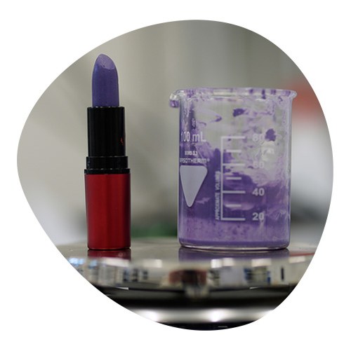 Make up/ Lipstick in laboratory placed near a test tube