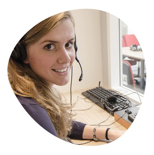 Student performing interpreting activities in the classroom with headphones and microphone