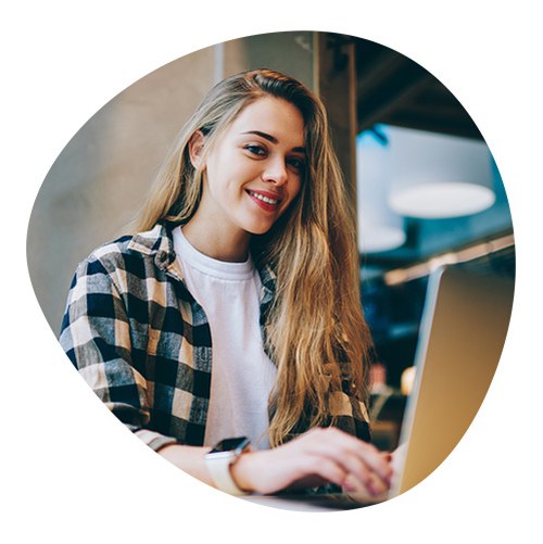 A smiling student working on the computer