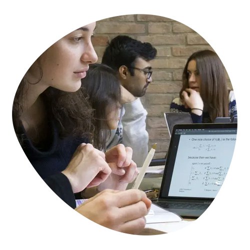 Group of students studying in the classroom and conversing with each other