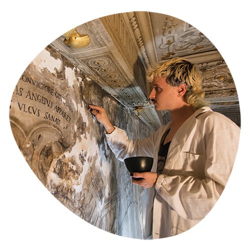 Student working on restoration of a fresco