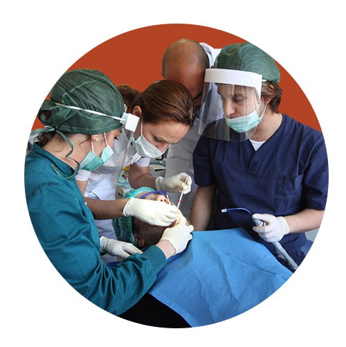 Group of students operating a patient in dental office